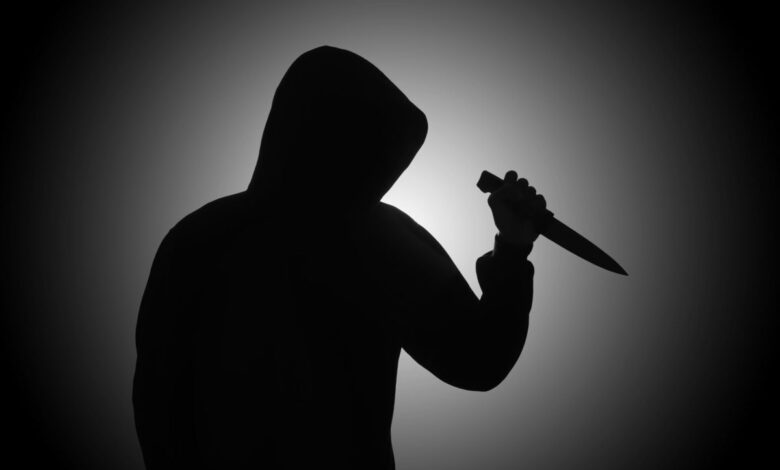 Vecteezy mysterious man wearing black hoodie holding a knife to stab 2410113428229 scaled.jpg