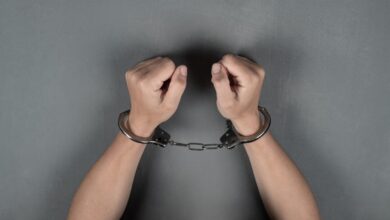 Vecteezy woman s hands are handcuffed against a gray wall 3313781 scaled.jpg