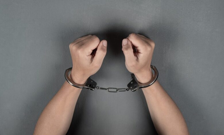 Vecteezy woman s hands are handcuffed against a gray wall 3313781 scaled.jpg