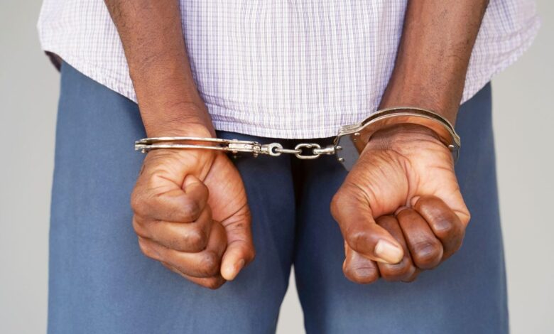 Vecteezy black hands locked in handcuffs close up view 6934437728129 scaled.jpg