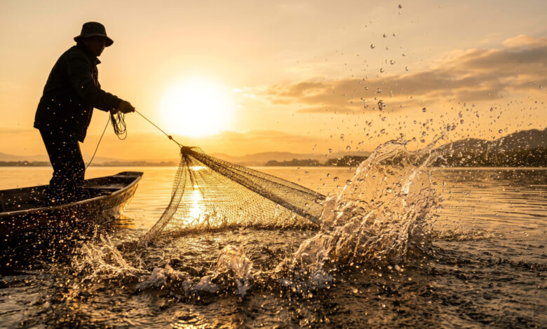 Vecteezy silhouetted fisherman pulls a net from a lake during golden 81896045 scaled.jpeg
